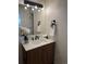 The bathroom features a granite countertop, wood vanity, and brushed black hardware at 2724 S Ames Way, Denver, CO 80227