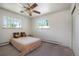 Bedroom features a ceiling fan and two bright windows at 2724 S Ames Way, Denver, CO 80227