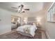 Comfortable bedroom with a ceiling fan, large window, and closet at 2724 S Ames Way, Denver, CO 80227