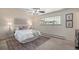 Comfortable bedroom with a ceiling fan, large window, and neutral decor for a relaxing atmosphere at 2724 S Ames Way, Denver, CO 80227