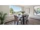 Cozy dining room featuring a modern table set, large windows for natural light, and neutral decor at 2724 S Ames Way, Denver, CO 80227