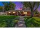 Charming brick home with a well-manicured lawn, beautiful landscaping and a welcoming walkway at 2724 S Ames Way, Denver, CO 80227