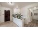Inviting hallway with tile floors, decorative plants, and access to multiple rooms in the home at 2724 S Ames Way, Denver, CO 80227
