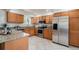 Well-equipped kitchen with stainless steel appliances, granite countertops, and ample cabinet space at 2724 S Ames Way, Denver, CO 80227