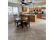 Open concept kitchen with an island, granite countertops, stainless steel appliances and a breakfast nook at 2724 S Ames Way, Denver, CO 80227