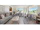 Bright living room with hardwood floors, large windows, and modern furnishings for a comfortable living space at 2724 S Ames Way, Denver, CO 80227