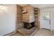 Living room features a stone fireplace with built-in shelves and a white entry door at 2724 S Ames Way, Denver, CO 80227