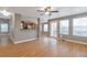 Spacious living room with hardwood floors, large windows, and an open layout to the kitchen at 4453 W Mountain Vista Ln, Castle Rock, CO 80109