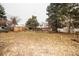 Spacious backyard with mature trees and falling leaves at 4263 S Elati St, Englewood, CO 80110