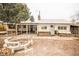 View of a house with a fire pit and patio in the backyard at 4263 S Elati St, Englewood, CO 80110