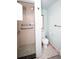 Dated bathroom featuring a shower, grab bars, commode, and vintage mosaic tile flooring at 4263 S Elati St, Englewood, CO 80110