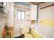 Outdated bathroom with a window, bathtub, and toilet surrounded by vintage tile and built-in shelves at 4263 S Elati St, Englewood, CO 80110