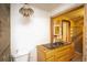 View of a bathroom with an exposed brick accent wall and fixtures at 4263 S Elati St, Englewood, CO 80110