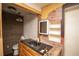 View of a bathroom with vanity sink and fixtures, exposed brick and shelving at 4263 S Elati St, Englewood, CO 80110