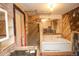 Bathroom featuring exposed brick, vanity, bathtub and shelving at 4263 S Elati St, Englewood, CO 80110