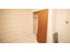 Spare bedroom featuring an empty closet with shelf and sliding wood door, plus wood-paneled wall trim at 4263 S Elati St, Englewood, CO 80110