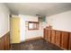 Retro bedroom featuring wood paneled walls, laminate flooring, built-in cabinetry and a window at 4263 S Elati St, Englewood, CO 80110