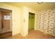 Bedroom featuring vintage wallpaper, a closet, and doorway leading to the exterior at 4263 S Elati St, Englewood, CO 80110