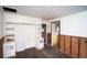 Retro room features paneling and built-in cabinets; view to an adjacent room with vintage kitchen appliances at 4263 S Elati St, Englewood, CO 80110