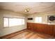 Empty room featuring wood paneling, painted walls, and a large window overlooking the exterior at 4263 S Elati St, Englewood, CO 80110