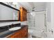Bathroom featuring a dark vanity with granite countertop and glass-enclosed shower at 615 S Alton Way # 7A, Denver, CO 80247