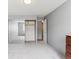 Bright bedroom featuring neutral walls, carpeted floor, and sliding mirror closet doors at 615 S Alton Way # 7A, Denver, CO 80247