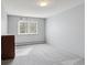 Cozy bedroom with large window, soft carpeting, and neutral color scheme at 615 S Alton Way # 7A, Denver, CO 80247
