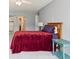 Bedroom featuring a modern lamp, side table, and neutral-colored walls with carpeting at 615 S Alton Way # 7A, Denver, CO 80247