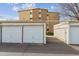 Detached garages provide convenient parking, with a building in the background at 615 S Alton Way # 7A, Denver, CO 80247