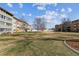 Well-maintained grounds featuring a grassy area, mature trees, and manicured landscaping at 615 S Alton Way # 7A, Denver, CO 80247