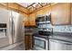 Close-up showcasing stainless steel appliances, modern countertops, and wooden cabinetry in the updated kitchen at 615 S Alton Way # 7A, Denver, CO 80247