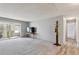 Open living room with large glass doors to the patio and neutral carpeting at 615 S Alton Way # 7A, Denver, CO 80247