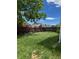 Backyard with overgrown grass and wooden fence at 14425 E Albrook Dr, Denver, CO 80239