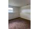 Neutral basement with carpet flooring and a window at 14425 E Albrook Dr, Denver, CO 80239