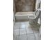 Cozy bathroom with tub and tile flooring at 14425 E Albrook Dr, Denver, CO 80239