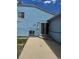 Side exterior of a blue home with a concrete patio at 14425 E Albrook Dr, Denver, CO 80239