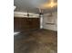 Spacious garage featuring concrete flooring and a wooden door at 14425 E Albrook Dr, Denver, CO 80239