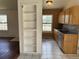 Functional kitchen featuring tile flooring, wood cabinets, and modern sink at 14425 E Albrook Dr, Denver, CO 80239