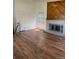 Bright living room with hardwood floors and a brick fireplace at 14425 E Albrook Dr, Denver, CO 80239