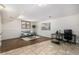 Finished basement area featuring a gray sofa, desk space, and a window for natural light at 7238 W Cedar Cir, Lakewood, CO 80226