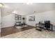 Finished basement featuring both hardwood floors and tile, a couch, and a desk with monitor at 7238 W Cedar Cir, Lakewood, CO 80226