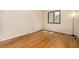 Light-filled bedroom featuring hardwood floors, natural light, and neutral walls at 7238 W Cedar Cir, Lakewood, CO 80226