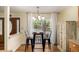 Charming breakfast nook with hardwood floors, modern light fixture, and views to the front porch at 7238 W Cedar Cir, Lakewood, CO 80226