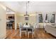 This dining room boasts hardwood floors, a dining table with seating for six, and bright natural light at 7238 W Cedar Cir, Lakewood, CO 80226