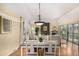This dining room features hardwood floors, natural light, and is open to the living room with fireplace at 7238 W Cedar Cir, Lakewood, CO 80226