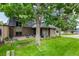This brick home boasts an outdoor patio, and landscaped yard maintained by a mature shade tree at 7238 W Cedar Cir, Lakewood, CO 80226