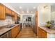 This kitchen features wood cabinets, stainless steel appliances, granite countertops, and hardwood floors at 7238 W Cedar Cir, Lakewood, CO 80226