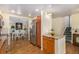This kitchen overlooks the living room and features wood cabinets, stainless steel appliances, and hardwood floors at 7238 W Cedar Cir, Lakewood, CO 80226