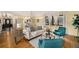 Spacious living room with hardwood floors and many windows providing natural light at 7238 W Cedar Cir, Lakewood, CO 80226