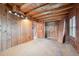 Room features wood paneled walls and ceiling, and a closet with a bi-fold door at 8409 S Otis St, Littleton, CO 80128